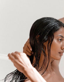 Handmade natural shampoo bar by Alux Cosmetics infused with rice hydrolysate, rosemary essential oil, and panthenol for strong, shiny, and nourished hair.